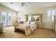 Sunlit main bedroom boasting plush carpet, plantation shutters, and a private balcony at 404 Via Sonador, Henderson, NV 89012