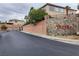 Gated community with manicured landscaping and stone signage at 404 Via Sonador, Henderson, NV 89012