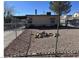 View of the gravel backyard area enclosed by chain link fence at 424 Jefferson Blvd, Henderson, NV 89011