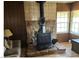Living room featuring a wood burning fireplace, tile and wood paneling at 424 Jefferson Blvd, Henderson, NV 89011