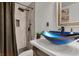 Chic bathroom showcasing a unique blue vessel sink with a rainfall shower and updated hardware at 5005 Harmony Ave, Las Vegas, NV 89107