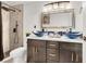 Stylish bathroom featuring modern fixtures including vessel sinks, updated shower and hardware at 5005 Harmony Ave, Las Vegas, NV 89107