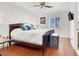 A cozy bedroom with a wooden bed frame, hardwood floors, and natural light from the window at 5005 Harmony Ave, Las Vegas, NV 89107