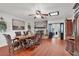 Spacious dining room with hardwood floors, a decorative ceiling fan, and a cozy fireplace at 5005 Harmony Ave, Las Vegas, NV 89107