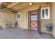 Inviting front porch features an outdoor seating area and a decorative front door at 5005 Harmony Ave, Las Vegas, NV 89107