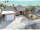 Aerial view of a cozy home with manicured front yard, mature tree, and driveway to garage at 5005 Harmony Ave, Las Vegas, NV 89107