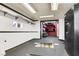 Spacious garage with custom shelving, interior lift, and fluorescent lighting at 5005 Harmony Ave, Las Vegas, NV 89107