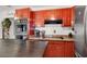 A traditional kitchen design with orange cabinetry, a built-in oven, and ample counter space at 5005 Harmony Ave, Las Vegas, NV 89107
