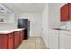 A well-lit laundry room featuring appliances, counter space, and cabinetry at 5005 Harmony Ave, Las Vegas, NV 89107
