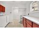 Bright laundry area with white appliances and storage racks with cabinets above at 5005 Harmony Ave, Las Vegas, NV 89107
