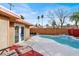 Backyard pool with a tranquil waterfall feature, complemented by an outdoor seating area at 5005 Harmony Ave, Las Vegas, NV 89107
