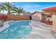 Inviting backyard pool with a waterfall feature and a lounge area perfect for relaxation and entertainment at 5005 Harmony Ave, Las Vegas, NV 89107