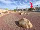 Street view of a community park with a gravel groundcover and mature landscaping at 5005 Harmony Ave, Las Vegas, NV 89107