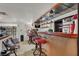 Entertainer's wet bar featuring barstool seating and decorative shelving for glassware at 5005 Harmony Ave, Las Vegas, NV 89107