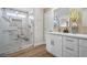 Modern bathroom featuring a glass-enclosed shower with marble accents and a white vanity at 5104 Elm Grove Dr, Las Vegas, NV 89130