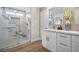 Beautiful bathroom featuring glass enclosed shower with marble surround, granite counters, and wood-look flooring at 5104 Elm Grove Dr, Las Vegas, NV 89130