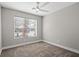 Neutral bedroom featuring carpet flooring, base trim, a ceiling fan, and window at 5104 Elm Grove Dr, Las Vegas, NV 89130
