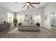 Spacious main bedroom featuring vaulted ceiling, ceiling fan, lots of natural light, and an ensuite bathroom at 5104 Elm Grove Dr, Las Vegas, NV 89130