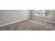 Neutral bedroom featuring carpet flooring, base trim, a window, and electrical outlets at 5104 Elm Grove Dr, Las Vegas, NV 89130