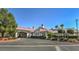 Exterior shot of a well-maintained community clubhouse with manicured landscaping and ample parking at 5104 Elm Grove Dr, Las Vegas, NV 89130