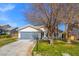 Charming single-story home with a well-manicured front lawn, mature tree and a two-car garage at 5104 Elm Grove Dr, Las Vegas, NV 89130
