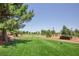 Picturesque golf course with manicured green grass, mature trees and clear blue sky at 5104 Elm Grove Dr, Las Vegas, NV 89130