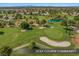 Scenic golf course community aerial view, highlighting the lush green fairways and serene water features at 5104 Elm Grove Dr, Las Vegas, NV 89130