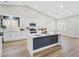 Modern kitchen with white cabinets, stainless steel appliances, and a center island with countertop dining at 5104 Elm Grove Dr, Las Vegas, NV 89130