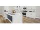 Modern kitchen with stainless appliances, white cabinets, and granite countertops and a large island at 5104 Elm Grove Dr, Las Vegas, NV 89130