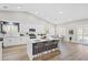 Bright kitchen features white cabinets, stainless steel appliances, and island with bar seating at 5104 Elm Grove Dr, Las Vegas, NV 89130