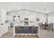 Bright kitchen features white cabinets, stainless steel appliances, island and eat-in kitchen at 5104 Elm Grove Dr, Las Vegas, NV 89130