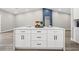 Kitchen island featuring white cabinets, quartz countertops, and a decorative fruit display at 5104 Elm Grove Dr, Las Vegas, NV 89130