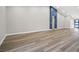 Minimalist living room with wood-look flooring and a unique blue accent wall at 5104 Elm Grove Dr, Las Vegas, NV 89130