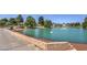 Scenic pond featuring lush landscaping, a charming fountain, and graceful swans at 5104 Elm Grove Dr, Las Vegas, NV 89130