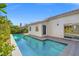 Inviting backyard pool with clear blue water, surrounded by lush greenery and a private patio at 5104 Elm Grove Dr, Las Vegas, NV 89130