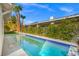 Inviting backyard pool with clear blue water, surrounded by lush greenery and palm trees at 5104 Elm Grove Dr, Las Vegas, NV 89130