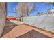 Backyard showcasing a rock garden area, privacy wall with decorative elements, and shade trees at 513 Elm St, Boulder City, NV 89005