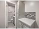 Bathroom showcasing gray cabinetry, marble countertop, and decorative tile accents at 513 Elm St, Boulder City, NV 89005