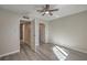 Bedroom featuring wood floors, bright lighting, and doors leading to bathroom at 513 Elm St, Boulder City, NV 89005