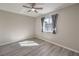 Bedroom featuring wood floors, a ceiling fan, and a window with curtains at 513 Elm St, Boulder City, NV 89005