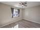 Neutral bedroom featuring hardwood floors and a window with curtains at 513 Elm St, Boulder City, NV 89005