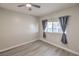 Neutral bedroom featuring wood floors, ceiling fan, and a window with curtains at 513 Elm St, Boulder City, NV 89005