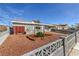 Beautifully landscaped front yard featuring a decorative fence and vibrant foliage at 513 Elm St, Boulder City, NV 89005