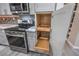 Gourmet kitchen details pull-out shelves, stainless appliances, and marble countertops at 513 Elm St, Boulder City, NV 89005