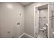 Spacious laundry area with a view into the updated bathroom and ample wall space at 513 Elm St, Boulder City, NV 89005