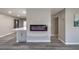 Modern living room with a fireplace feature, breakfast bar, and beautiful flooring at 513 Elm St, Boulder City, NV 89005