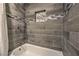 Modern shower featuring wood look tiling, decorative tile accents, and a built-in niche at 513 Elm St, Boulder City, NV 89005