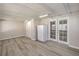 Bright sunroom with hardwood floors and white doors leading to the exterior at 513 Elm St, Boulder City, NV 89005