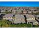 Expansive aerial view of a residential community with well-maintained homes, set against a backdrop of distant mountains at 5741 Shadow Bend Dr, Las Vegas, NV 89135