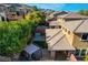 Aerial view of the backyard featuring lush landscaping, a hot tub, a pergola and patio seating at 5741 Shadow Bend Dr, Las Vegas, NV 89135